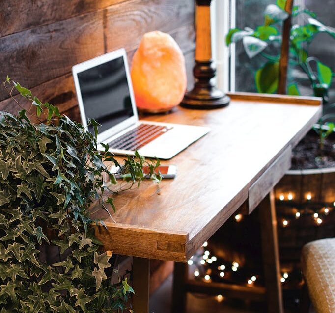 Himalayan Salt Lamp Near Laptop On Wooden Table